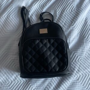 Elegant Black Quilted Backpack with Gold Accents